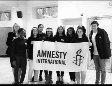 Pictured here is the board and other members of Amnesty International. From  left to right: Joy Oghenekome, Hope Li, Manahil Khan, Jenna Johnson, Sabia Akand, Emily Bridglall, Isabella Abbamonte, Robert Hager