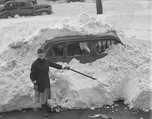 A woman digs after the blizzard. 1950